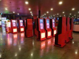 Cashless card system in an FEC: guest tapping an RFID game card on an arcade reader