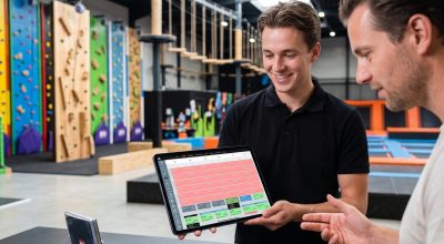 Adventure park management software in use: staff checking session bookings at an activity-led park